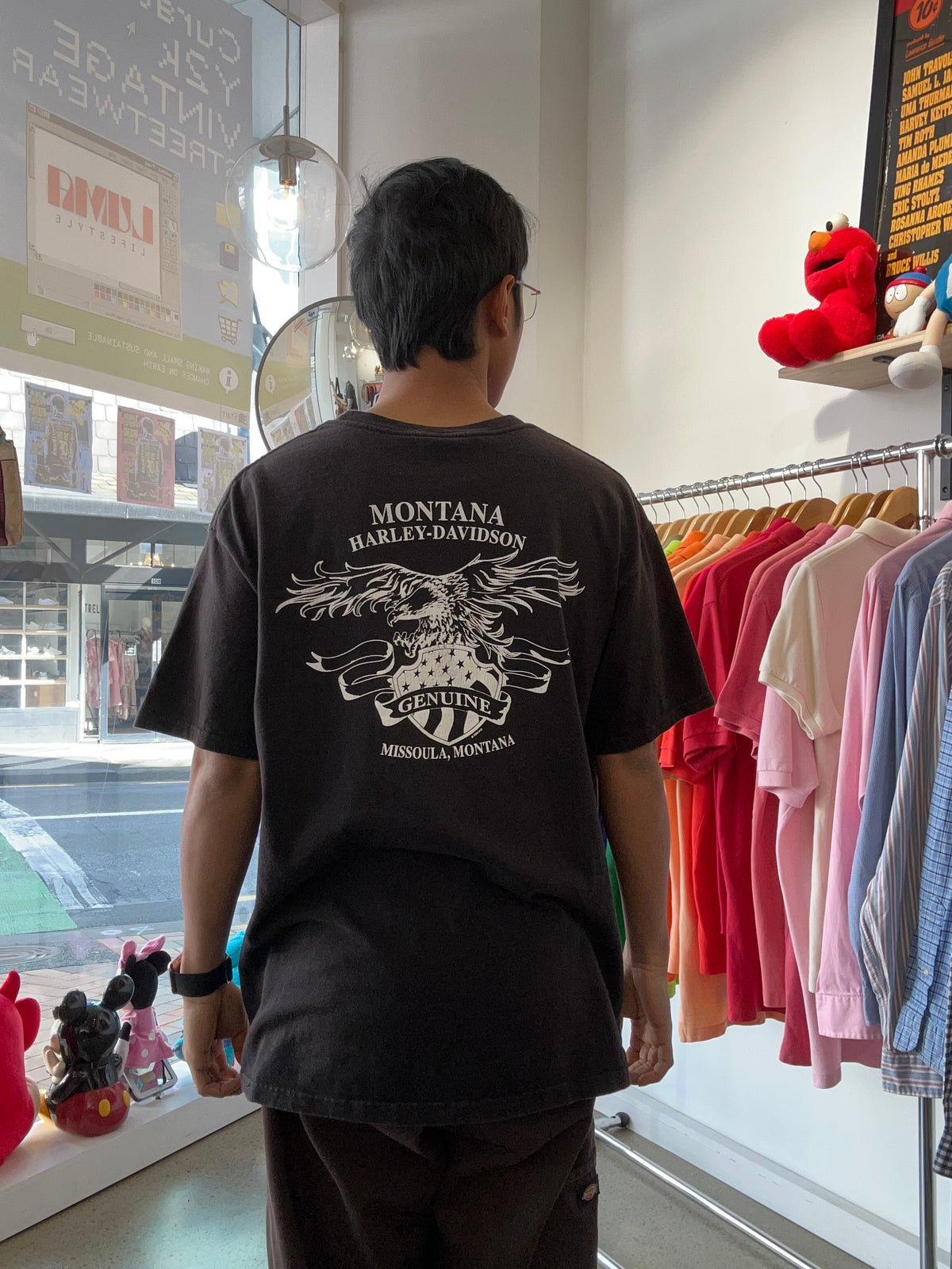vintage black Harley-Davidson t-shirt from Montana Harley-Davidson in Missoula, Montana, featuring a white eagle and shield graphic on the back Large