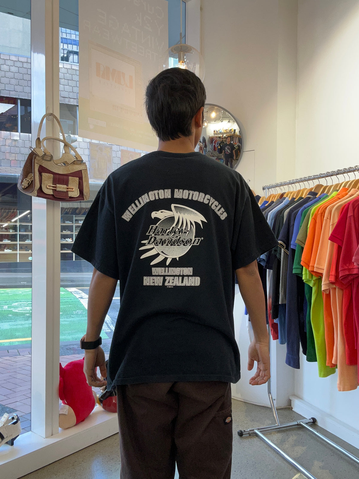 vintage black Harley-Davidson New Zealand graphic T-shirt featuring a Māori tiki or tribal design alongside the New Zealand flag.Wellington 1998