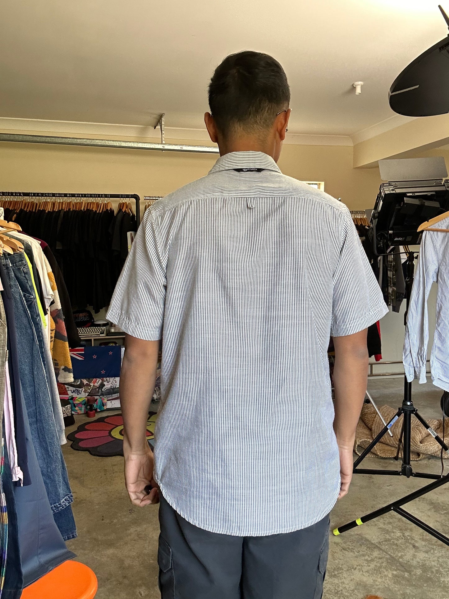 short-sleeve button-up shirt from the brand Stüssy, featuring a classic hickory stripe pattern and dual chest pockets.Medium