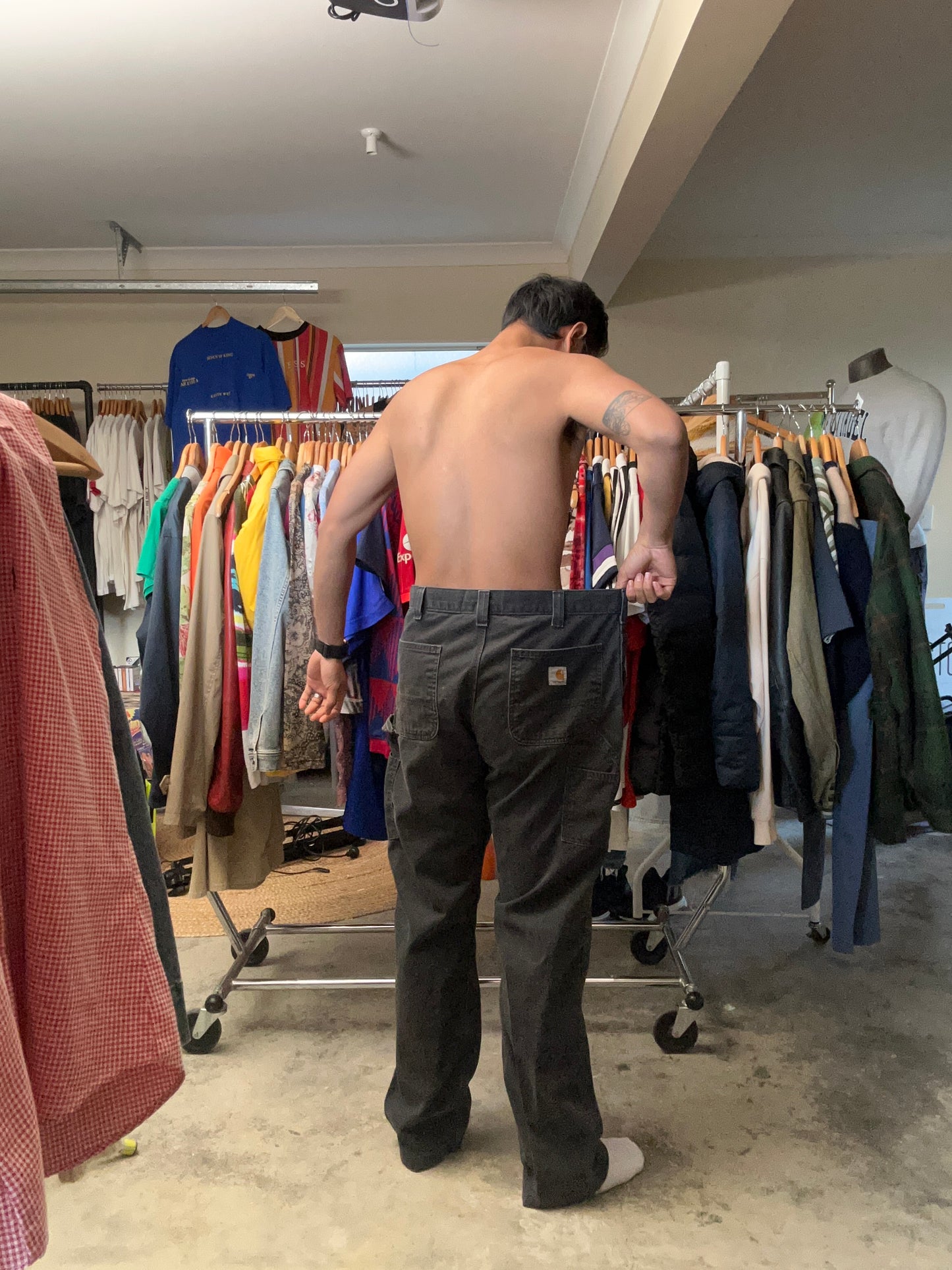 vintage Carhartt Carpenter pants, characterized by a faded black finish and utility features like a hammer loop size 36