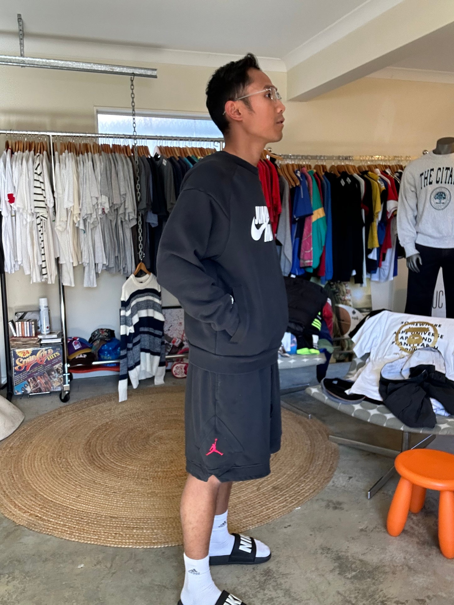 black Jordan Jumpman Men's Fleece Crew Sweatshirt, which features side pockets and a prominent white "JUMPMAN" graphic with the Nike swoosh Medium
