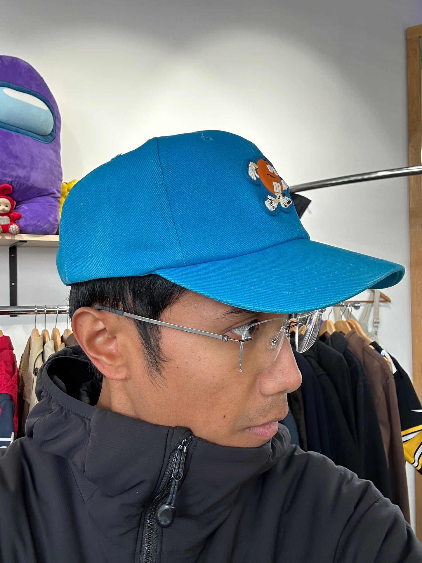 vintage 1999 M&M's Crispy "Orange" character advertising baseball cap in a vibrant turquoise blue.