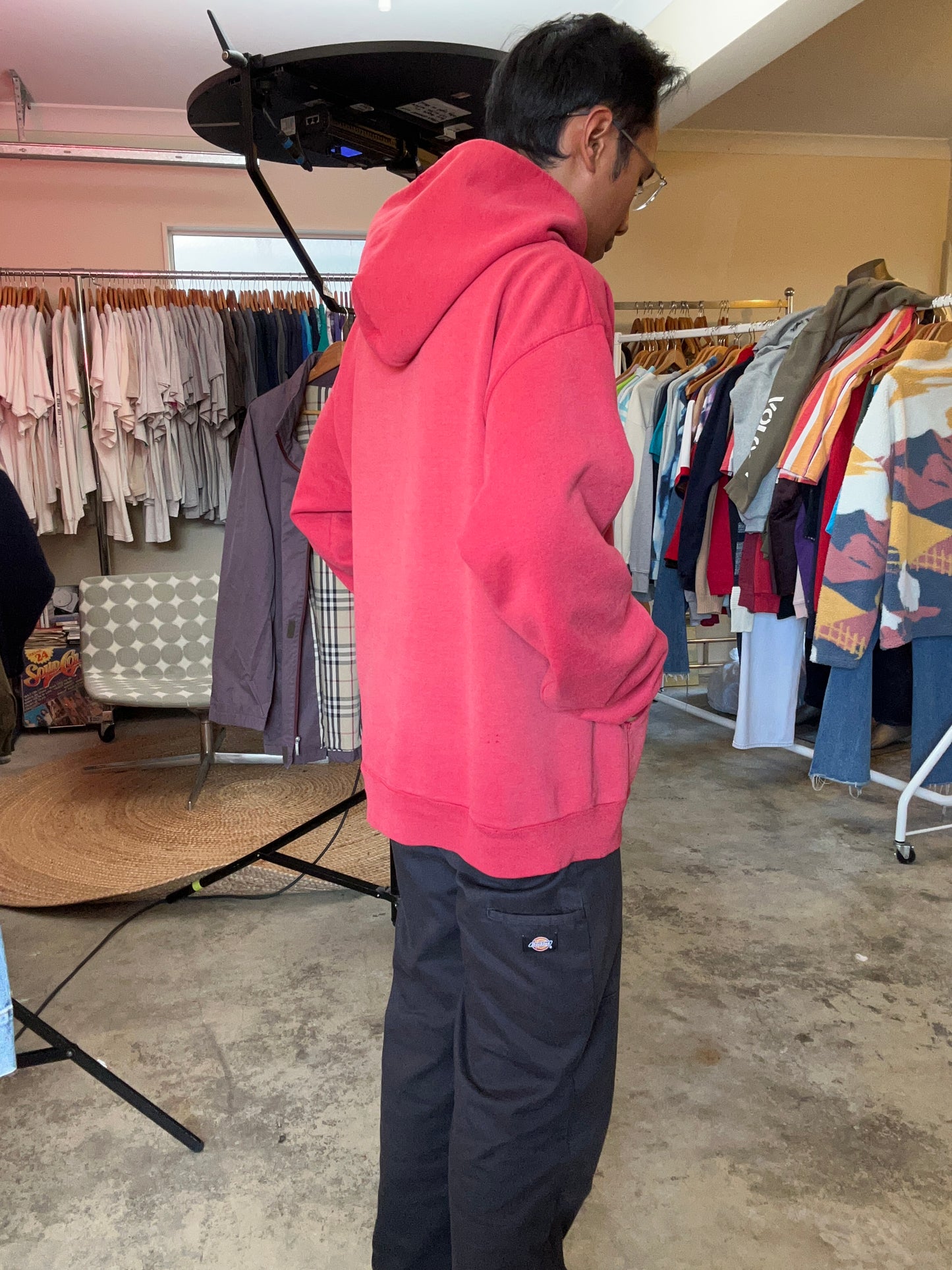 Vintage Fade red Champion hoodie features a prominent arched "HARVARD" spellout graphic and a comfortable kangaroo pocket Large