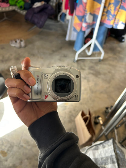 silver Canon PowerShot SX100 IS digital camera with a 10x optical zoom lens