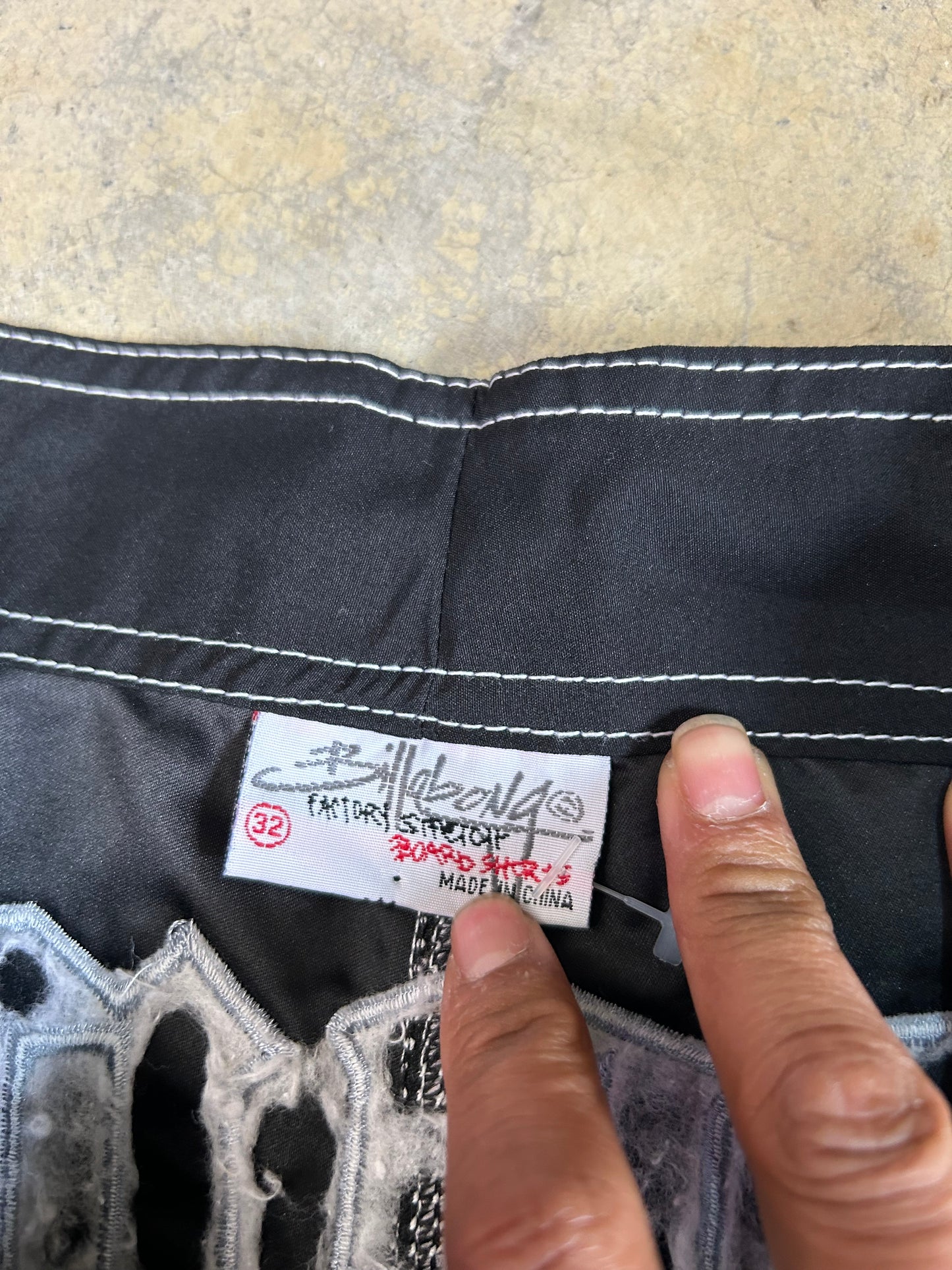 2000s Billabong black and grey plaid board shorts featuring a large embroidered logo on the back 32