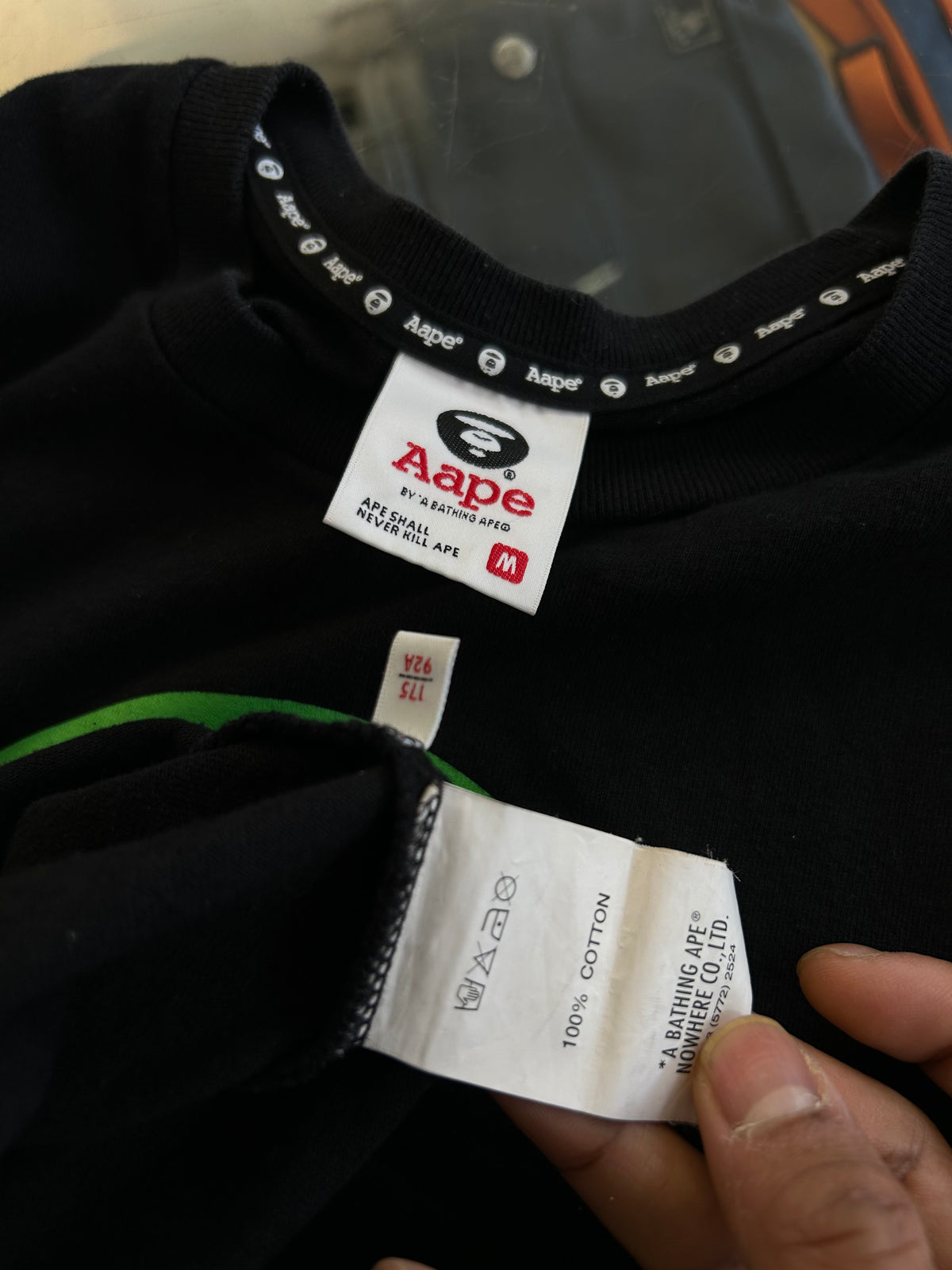 black AAPE by A Bathing Ape t-shirt featuring a vibrant rainbow gradient Ape Head logo on the chest Medium