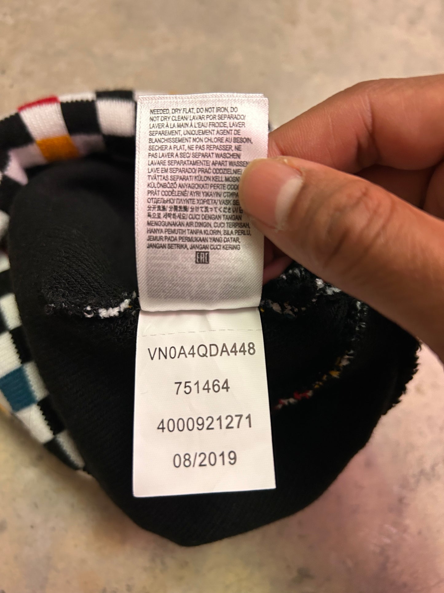 Vans Breakin Out Beanie features a multi-colored checkerboard pattern and a fold-over cuff with the iconic "Off The Wall" label