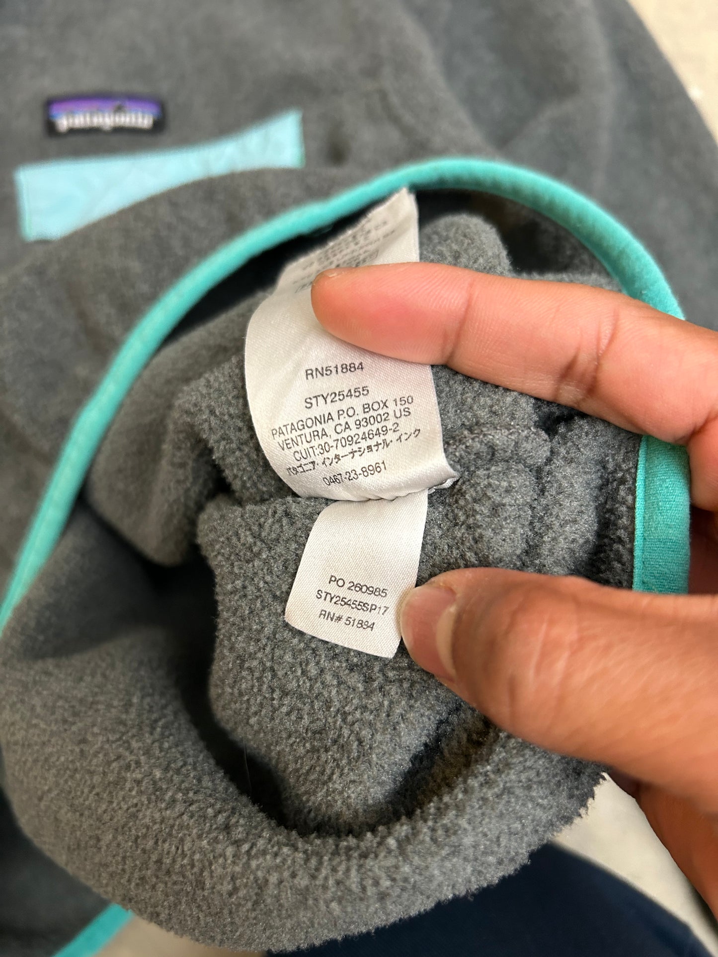Patagonia Lightweight Synchilla Snap-T Fleece Pullover in dark gray with teal accents Small