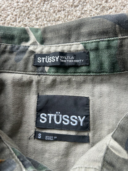 Stussy camouflage cargo shirt featuring a button-up front and a logo patch on the chest Medium
