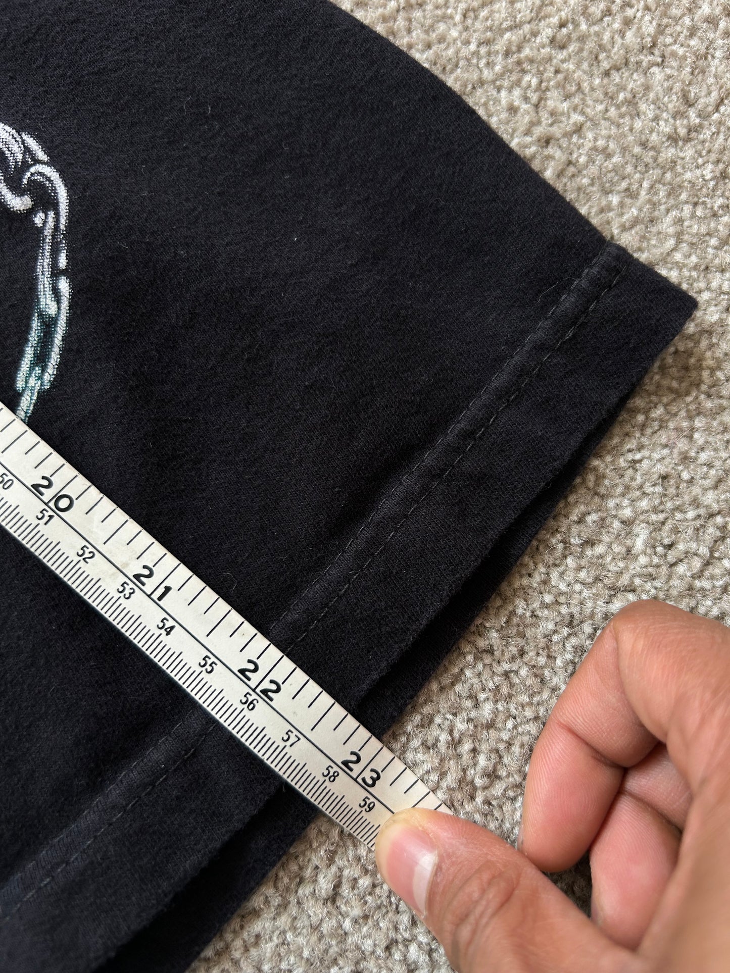 black graphic t-shirt featuring a skeleton playing an electric guitar Hot Rock Tee