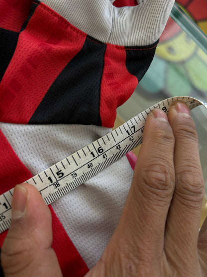 red and black striped Puma AC Milan 2024/25 home jersey featuring the white "Emirates Fly Better" sponsor logo XS