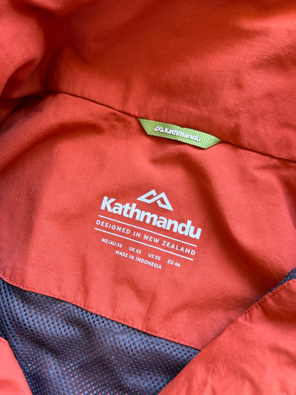 Kathmandu men's Andulo 2-layer rain jacket in a dark orange color Medium