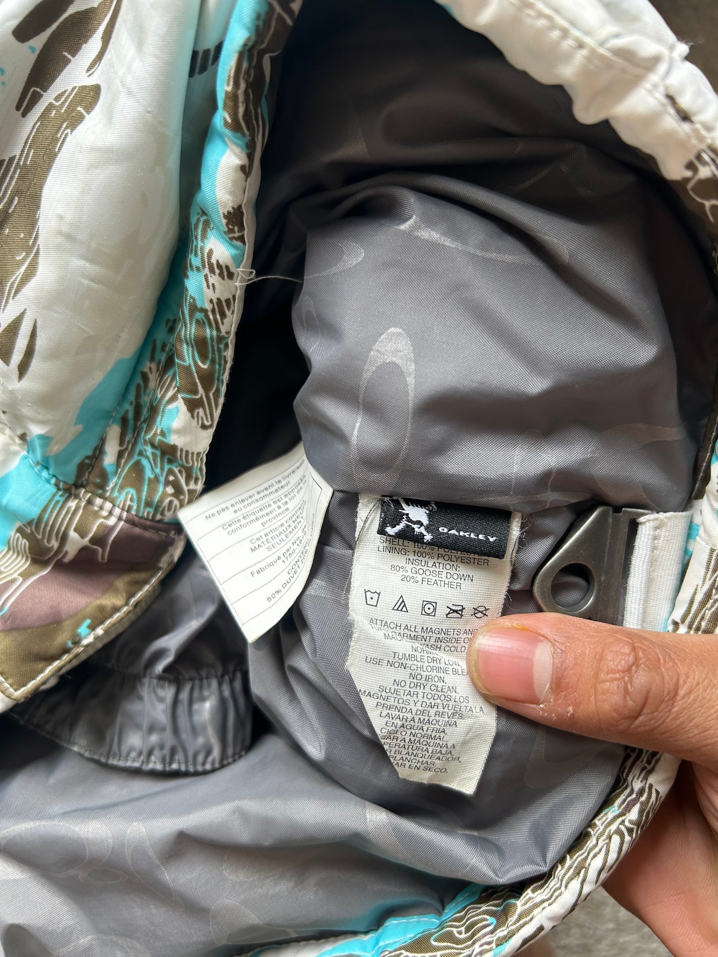Oakley Avalanche NVL4 snow jacket in a white, brown, and blue camouflage pattern Large