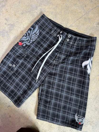 2000s Billabong black and grey plaid board shorts featuring a large embroidered logo on the back 32