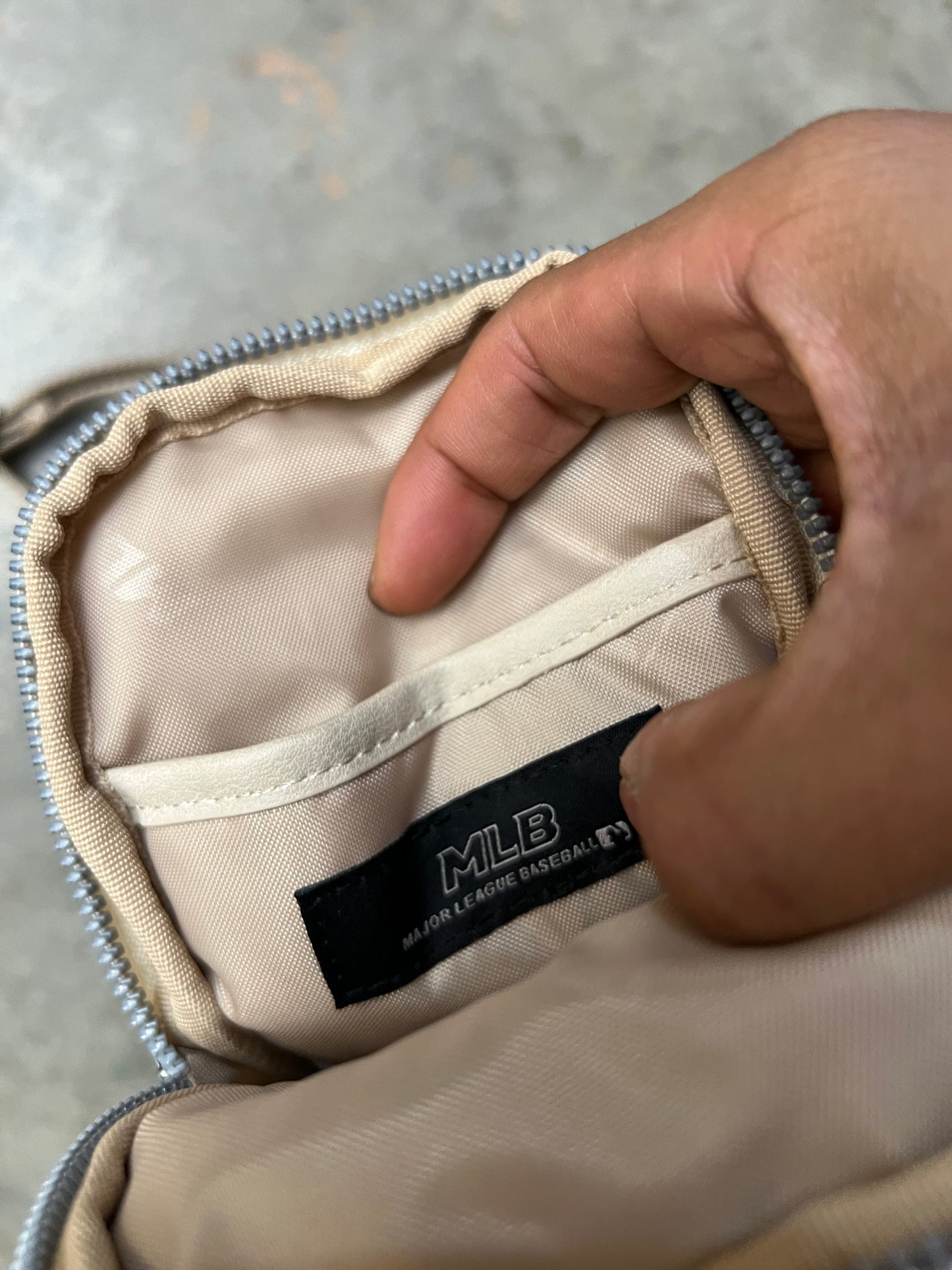 MLB New York Yankees mini bag features a repeating "NY" monogram pattern in ivory and blue