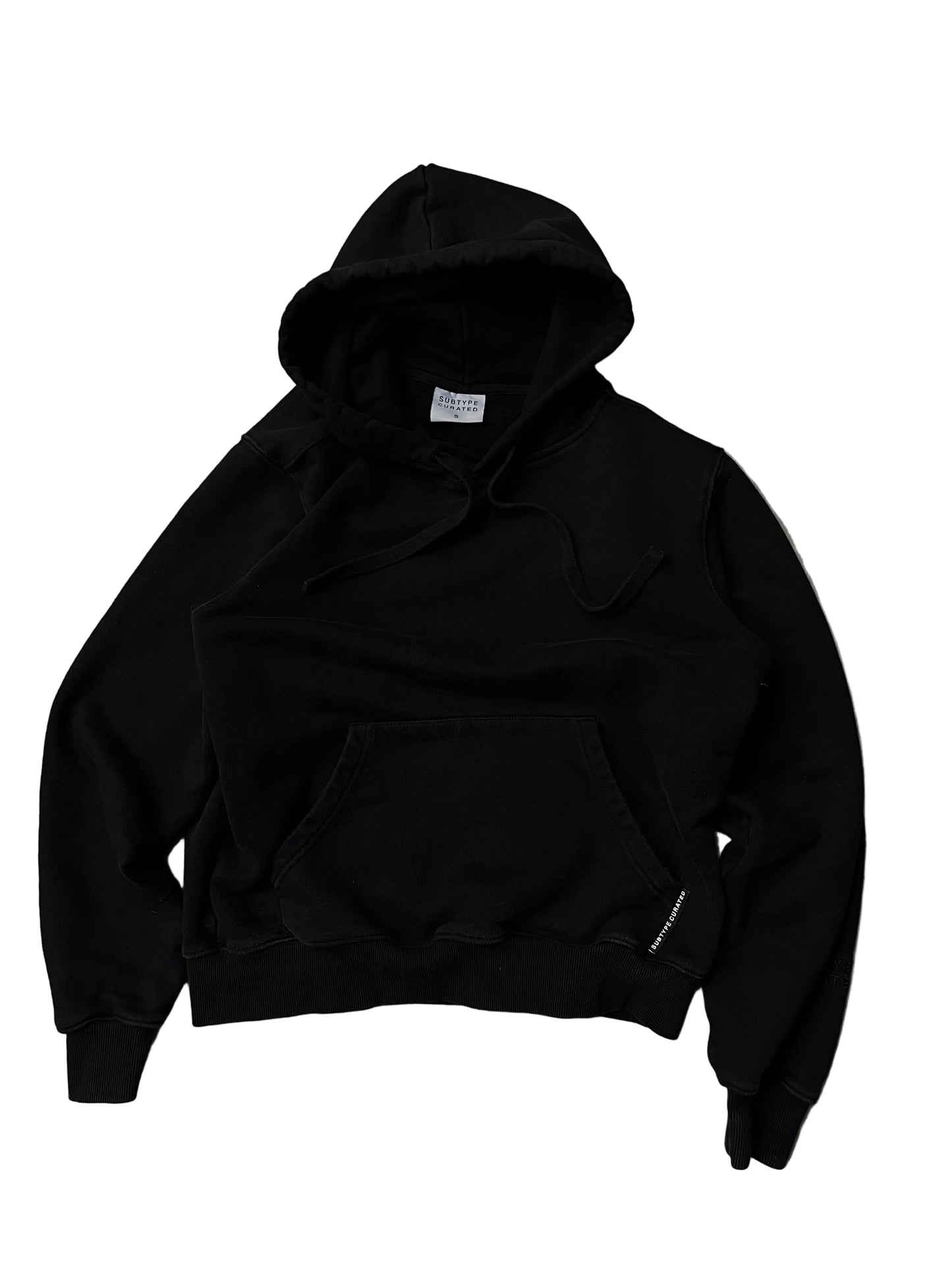 black Subtype Curated hoodie features a prominent kangaroo pocket and a clean, minimalist design Small