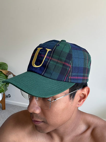 green and plaid Undefeated cap with a yellow embroidered "U" logo. Adjustable