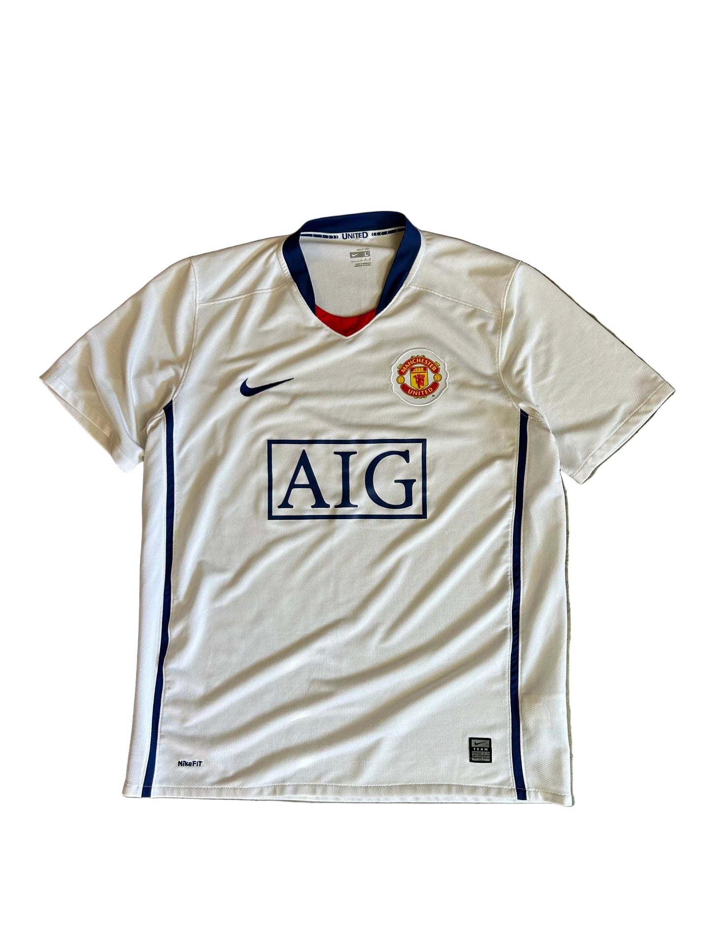 Nike Manchester United away jersey from the 2008-2009 season, featuring a classic white design with a blue V-neck and "AIG Large White