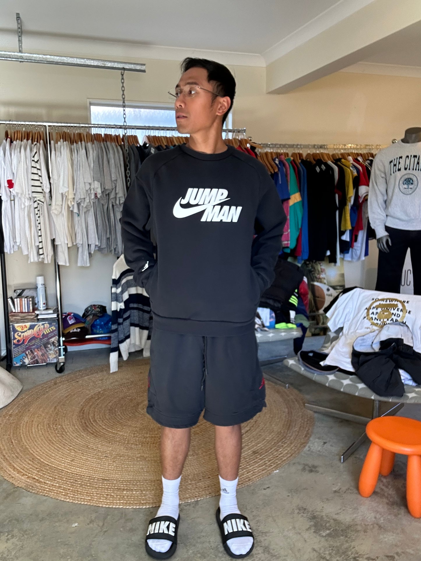 black Jordan Jumpman Men's Fleece Crew Sweatshirt, which features side pockets and a prominent white "JUMPMAN" graphic with the Nike swoosh Medium