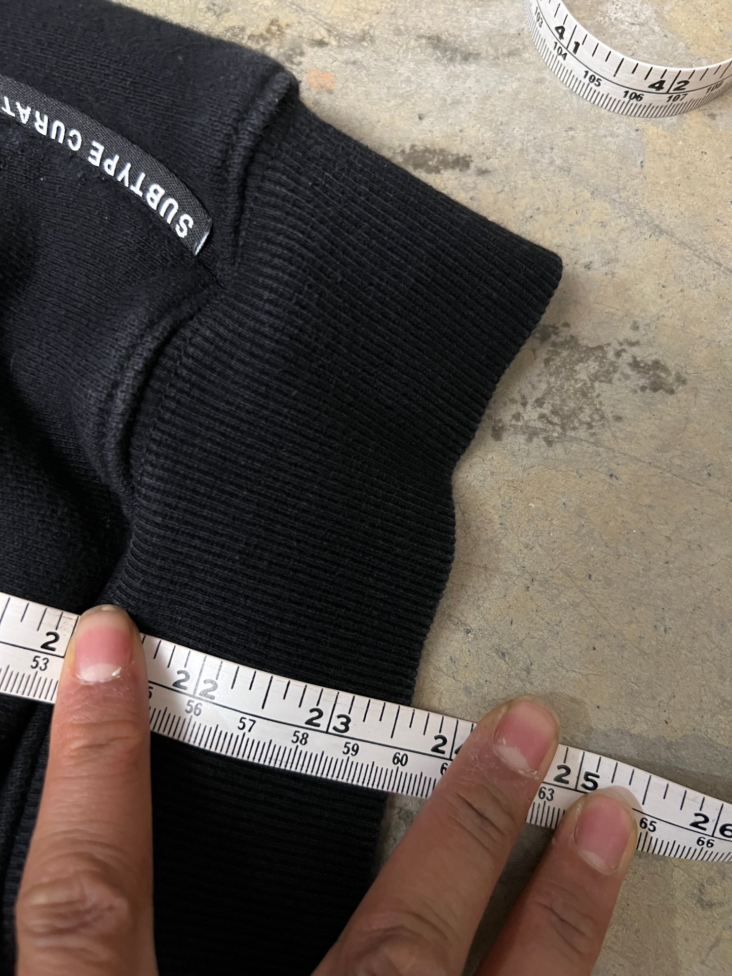 black Subtype Curated hoodie features a prominent kangaroo pocket and a clean, minimalist design Small