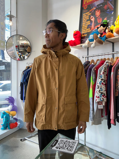 Uniqlo mustard yellow oversized hooded parka featuring large utility flap pockets on the front