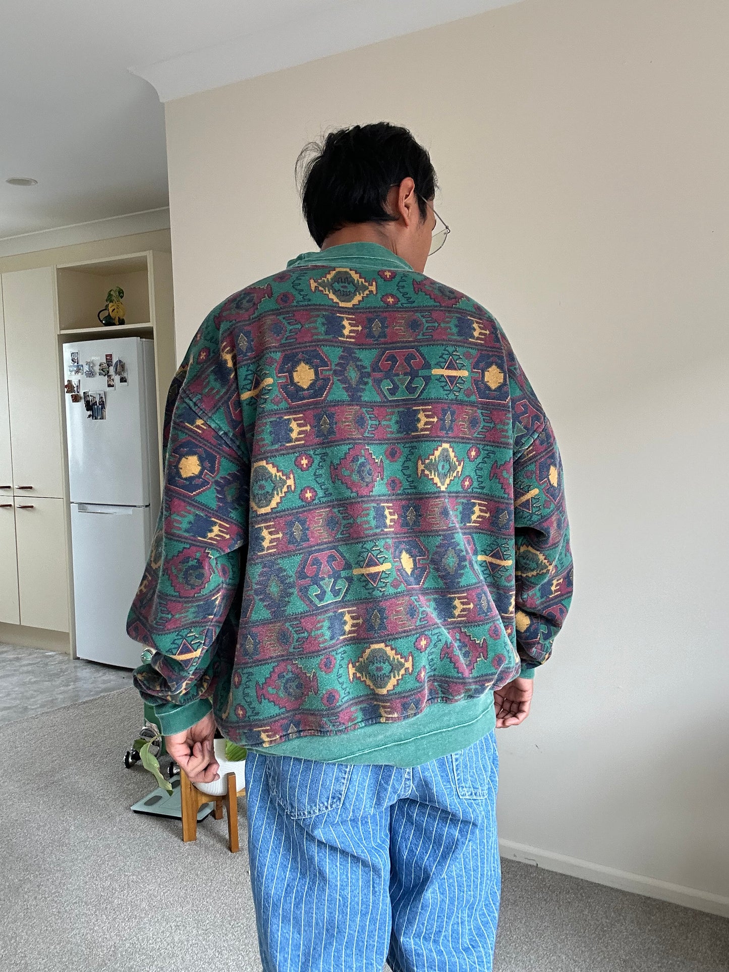 a dark green base with a multicolored Aztec and geometric pattern, characteristic of 1980s and 90s knitwear designs. XL