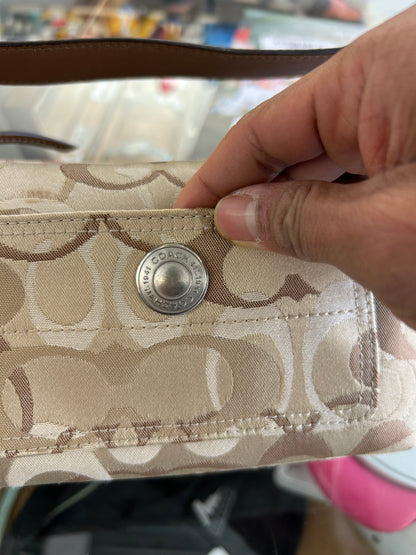vintage Coach signature jacquard mini shoulder bag featuring the iconic brown "C" monogram pattern and a handy front pocket with a snap closure.
