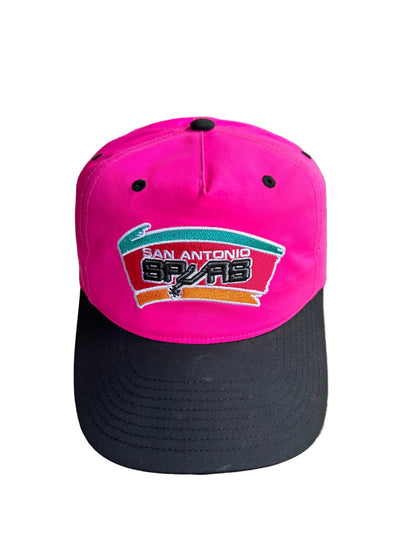 Pink and Black Mitchell & Ness San Antonio Spurs Hardwood Classics Snapback hat.