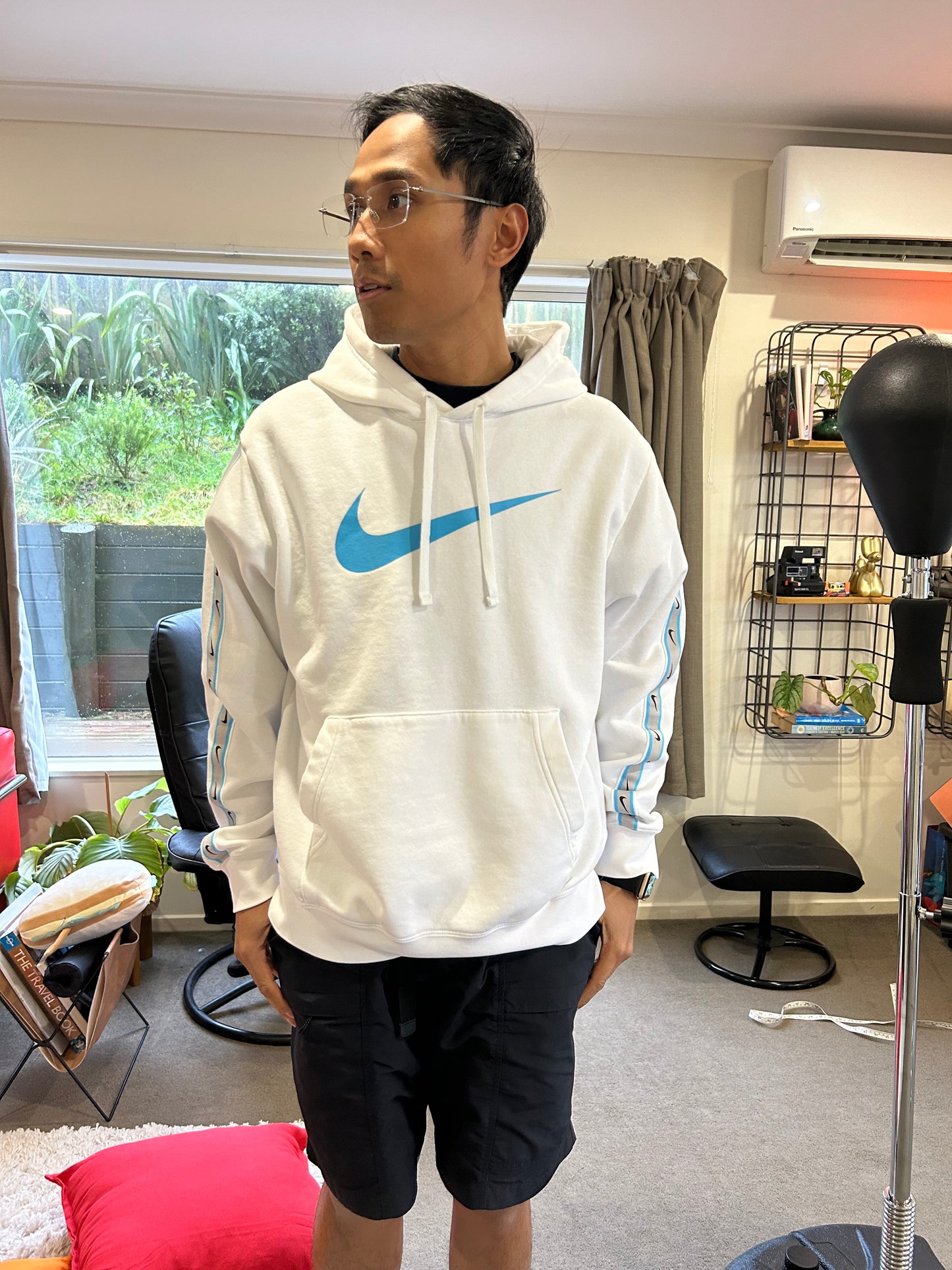 Nike Sportswear Repeat Fleece hoodie in summit white features distinctive Baltic blue branding on the chest and along the sleeves Medium