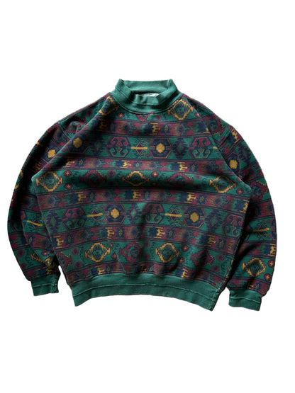 a dark green base with a multicolored Aztec and geometric pattern, characteristic of 1980s and 90s knitwear designs. XL