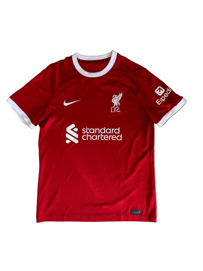 Nike Liverpool FC 2023/24 Home Jersey, featuring a classic red design with prominent white collar and sleeve cuffs. Medium
