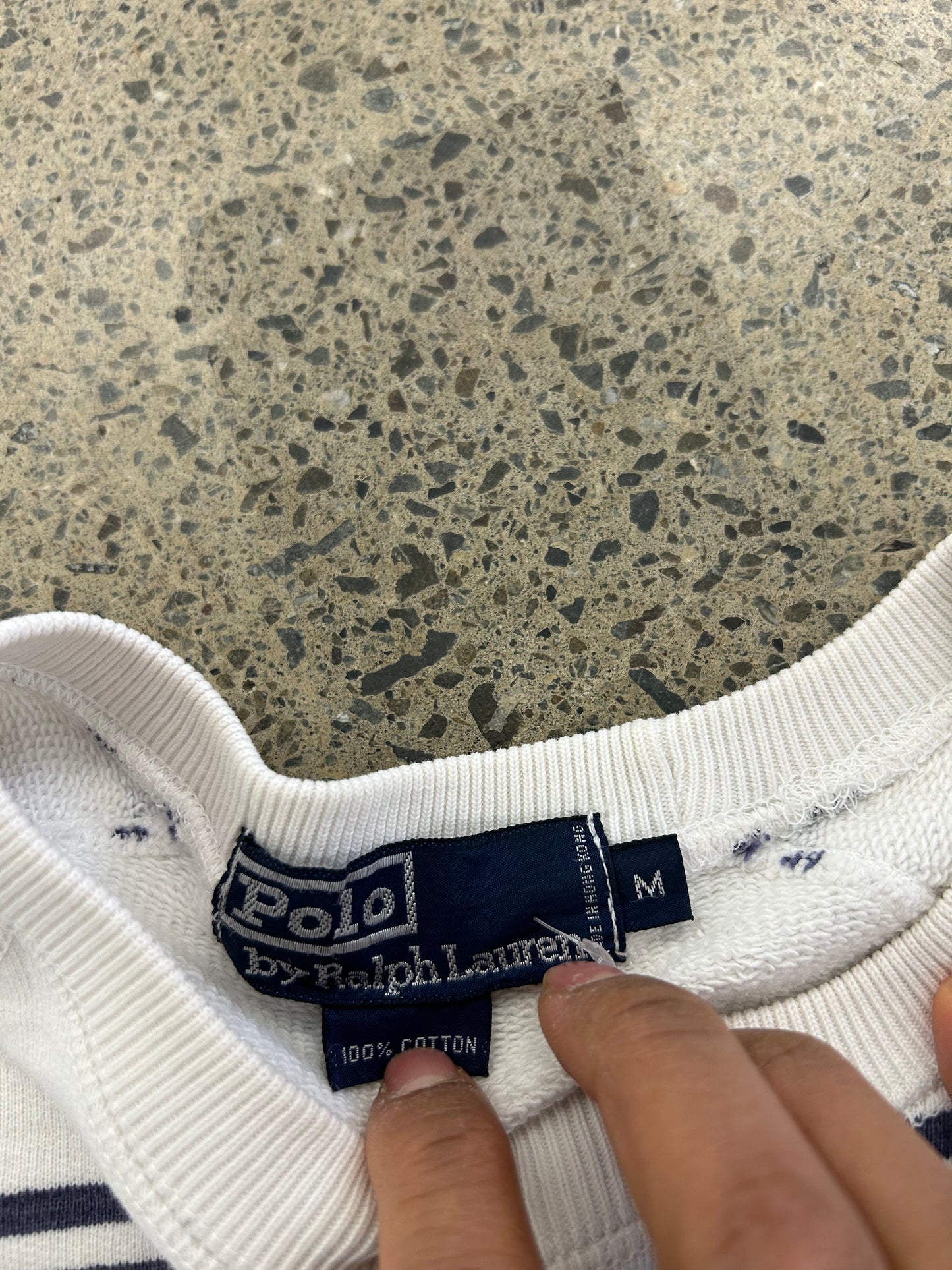 Vintage Polo Ralph Lauren striped crew neck sweater features a white base with navy horizontal stripes and an embroidered crest on the chest.