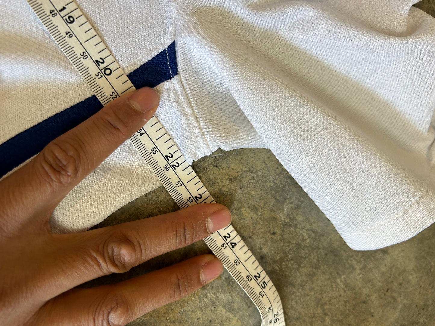 Nike Manchester United away jersey from the 2008-2009 season, featuring a classic white design with a blue V-neck and "AIG Large White