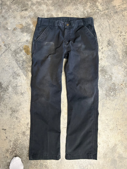 vintage Carhartt Carpenter pants, characterized by a faded black finish and utility features like a hammer loop size 36