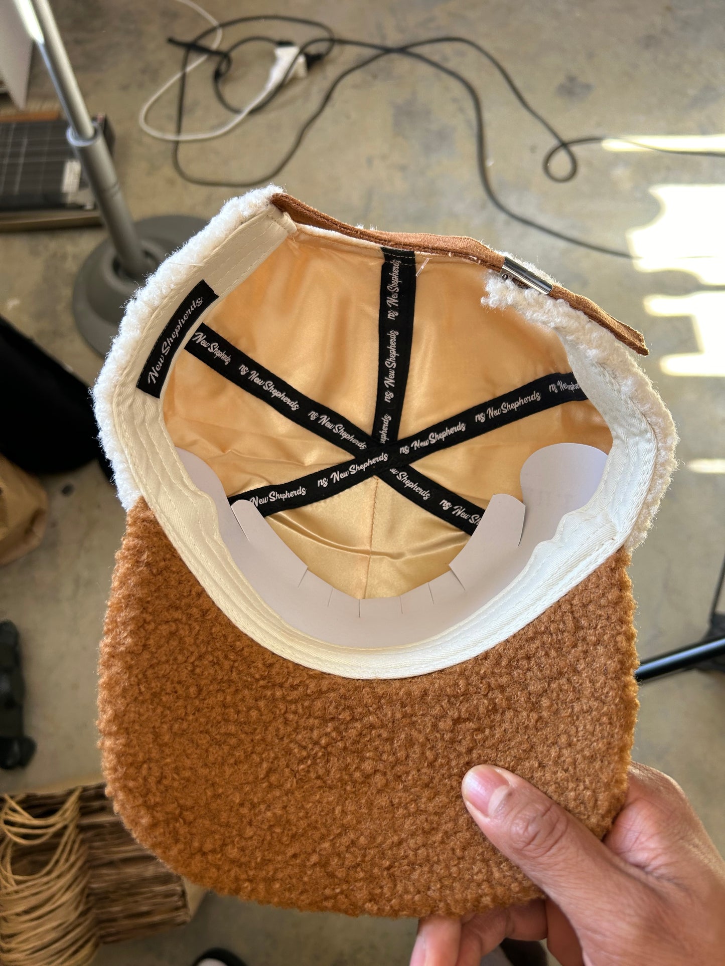 New Shepherds Sherpa Baseball Cap featuring a white fleece crown, a brown brim, and a gold embroidered 'B