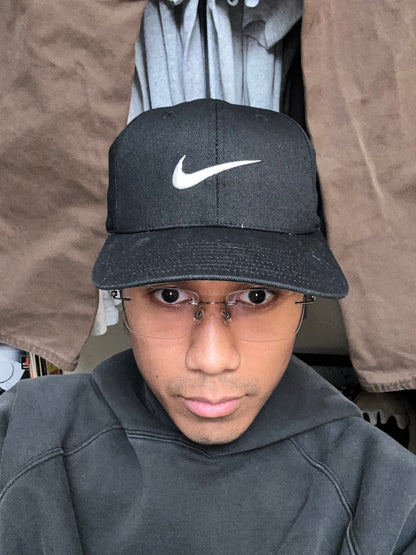 Vintage black Nike baseball cap featuring a white embroidered Swoosh Cotton