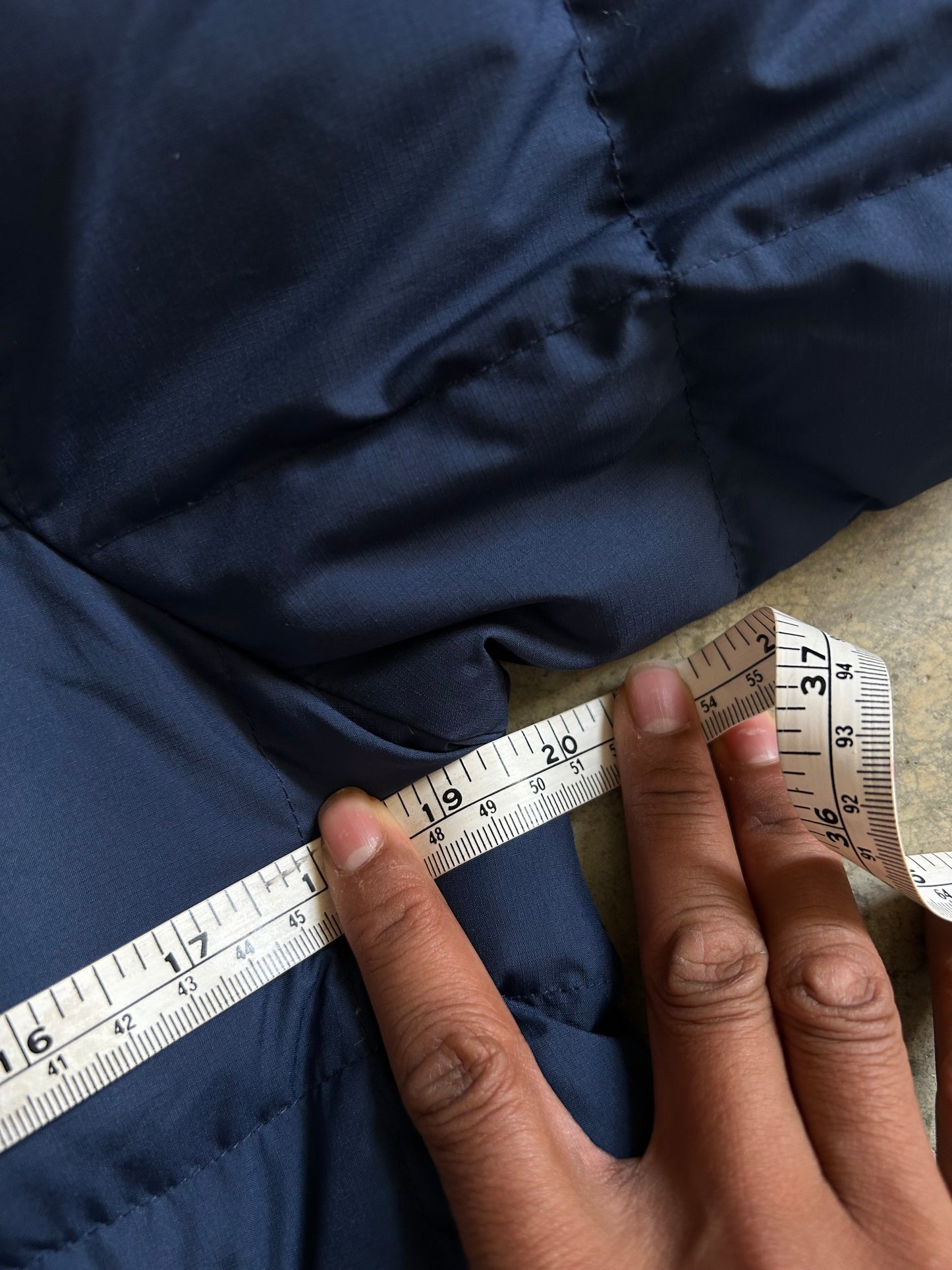 Pertex blue puffer jacket with a red inner lining and red zippers, produced by Levi's Small