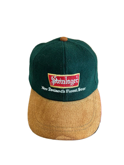vintage Steinlager two-tone cap featuring a dark green crown and a contrasting tan brim