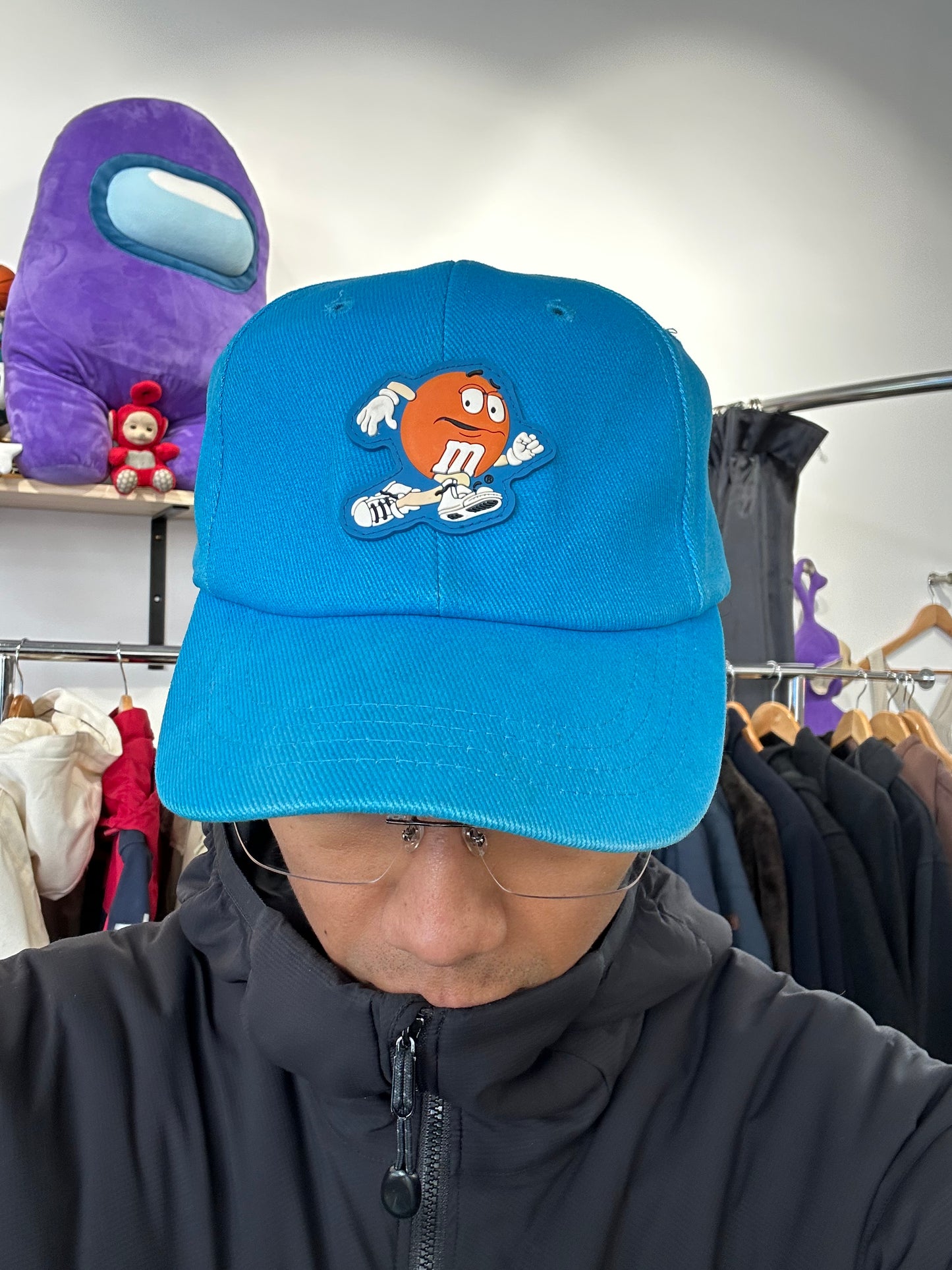 vintage 1999 M&M's Crispy "Orange" character advertising baseball cap in a vibrant turquoise blue.