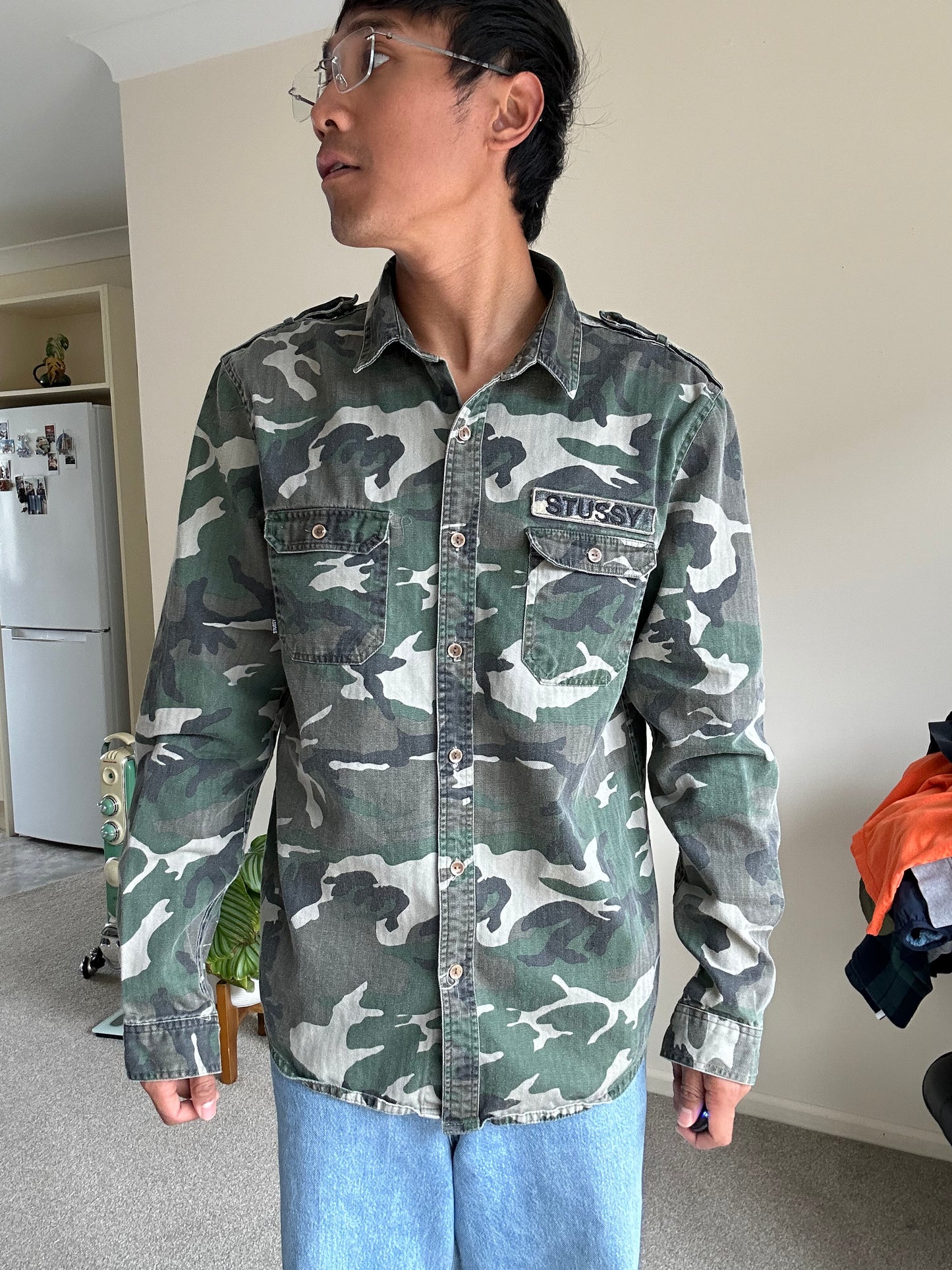 Stussy camouflage cargo shirt featuring a button-up front and a logo patch on the chest Medium