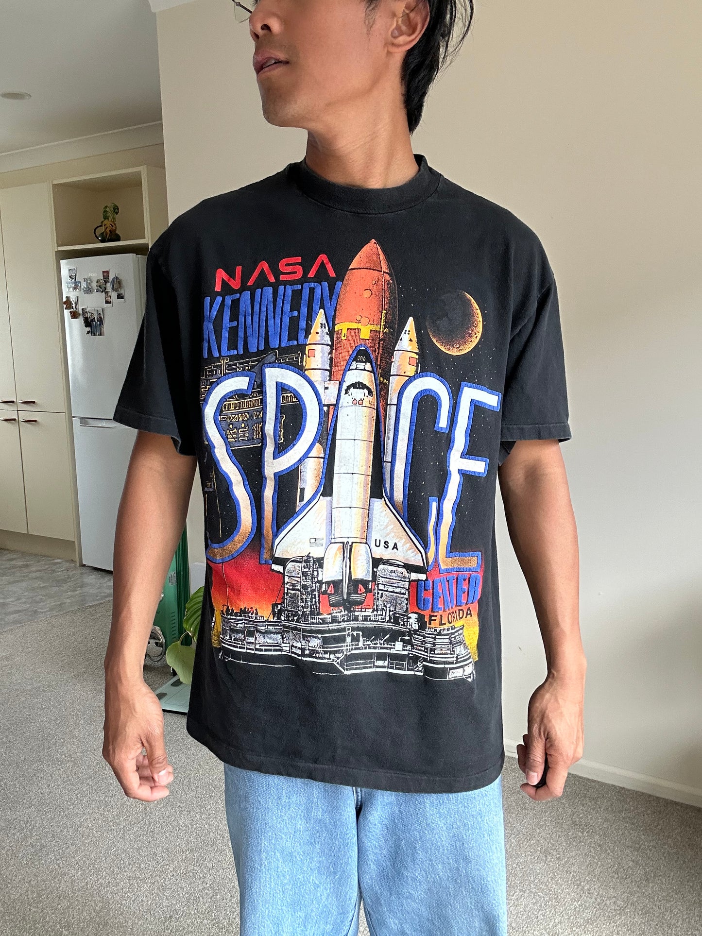 vintage 1990 Hanes Beefy-T t-shirt features a prominent graphic for the NASA Kennedy Space Center in Florida Large Black