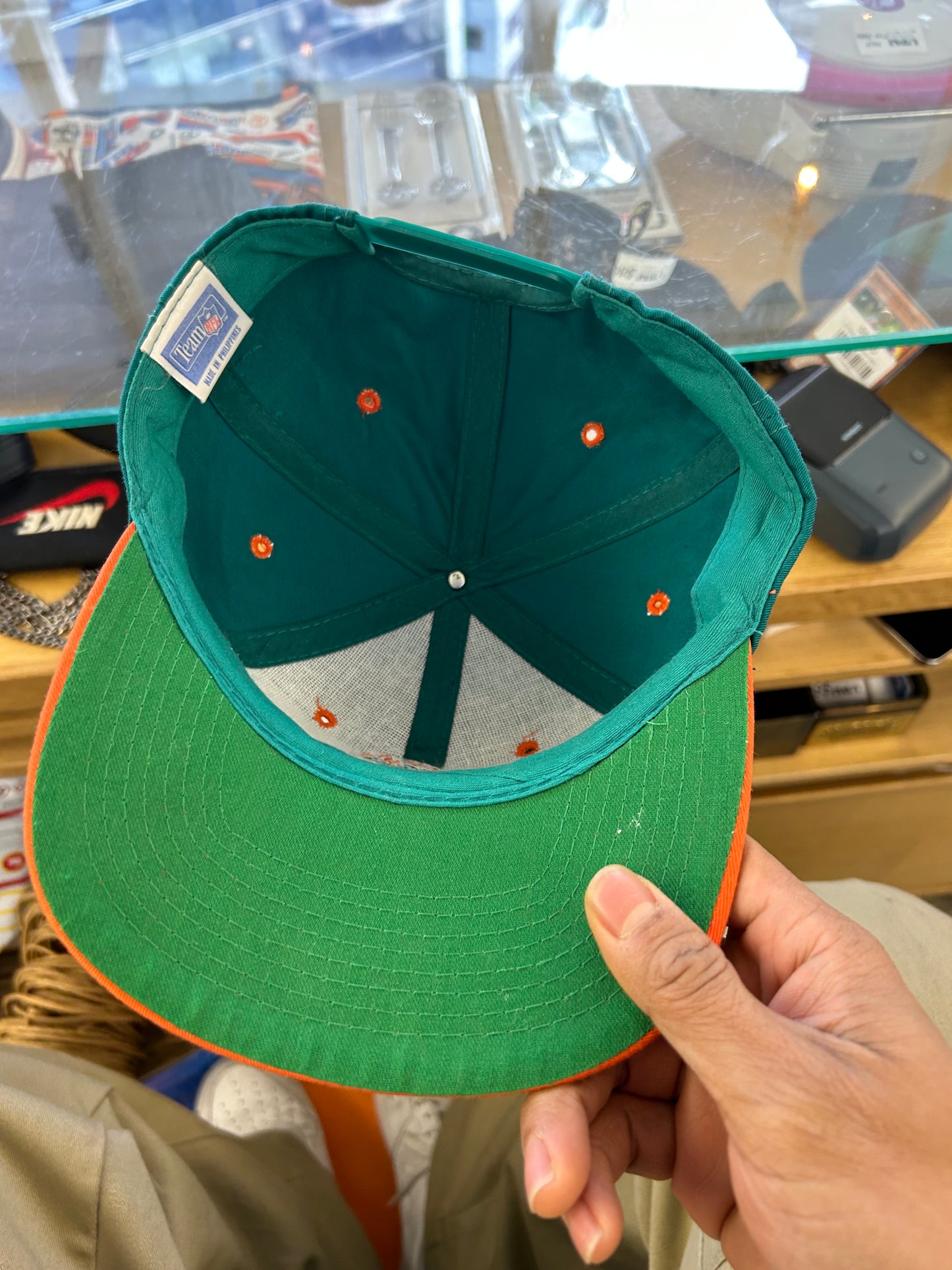 vintage Miami Dolphins snapback hat features a distinctive orange brim contrasting with a teal crown