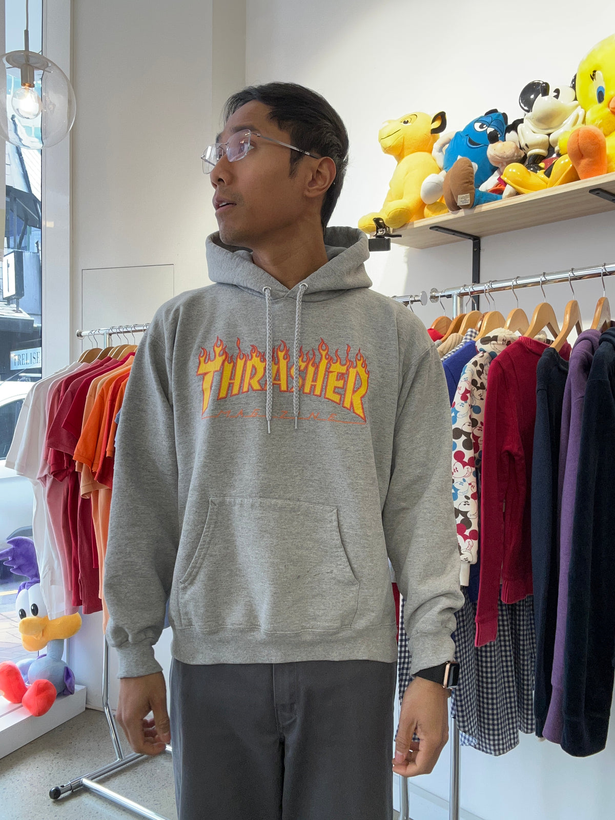 heather grey Thrasher hoodie features the brand's iconic yellow and red flame logo printed across the chest Small