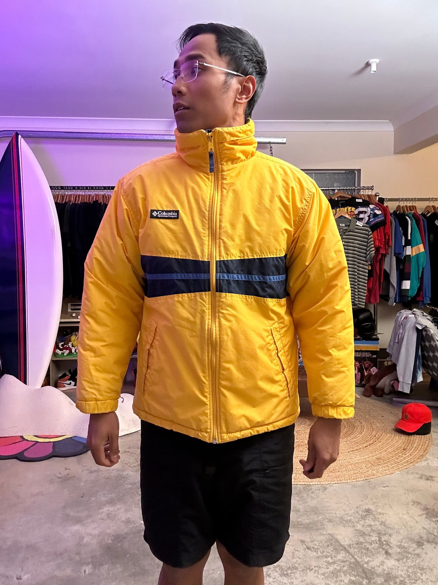 Medium vintage yellow Columbia Sportswear jacket with a blue stripe design across the chest. Has Stains