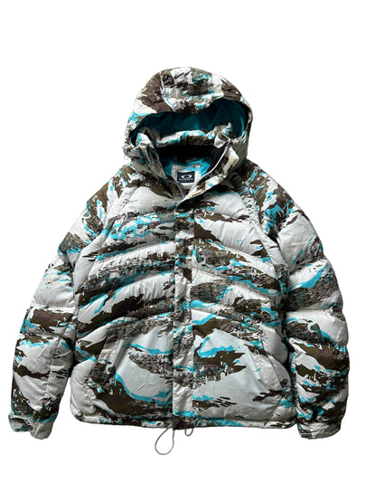 Oakley Avalanche NVL4 snow jacket in a white, brown, and blue camouflage pattern Large
