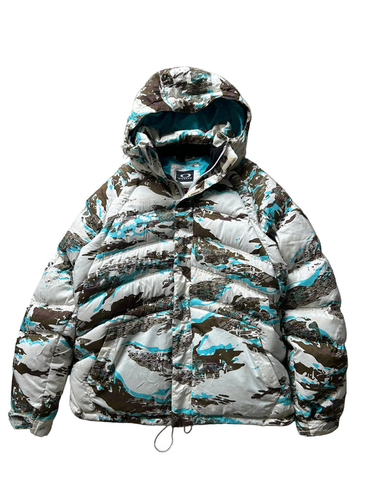 Oakley Avalanche NVL4 snow jacket in a white, brown, and blue camouflage pattern Large