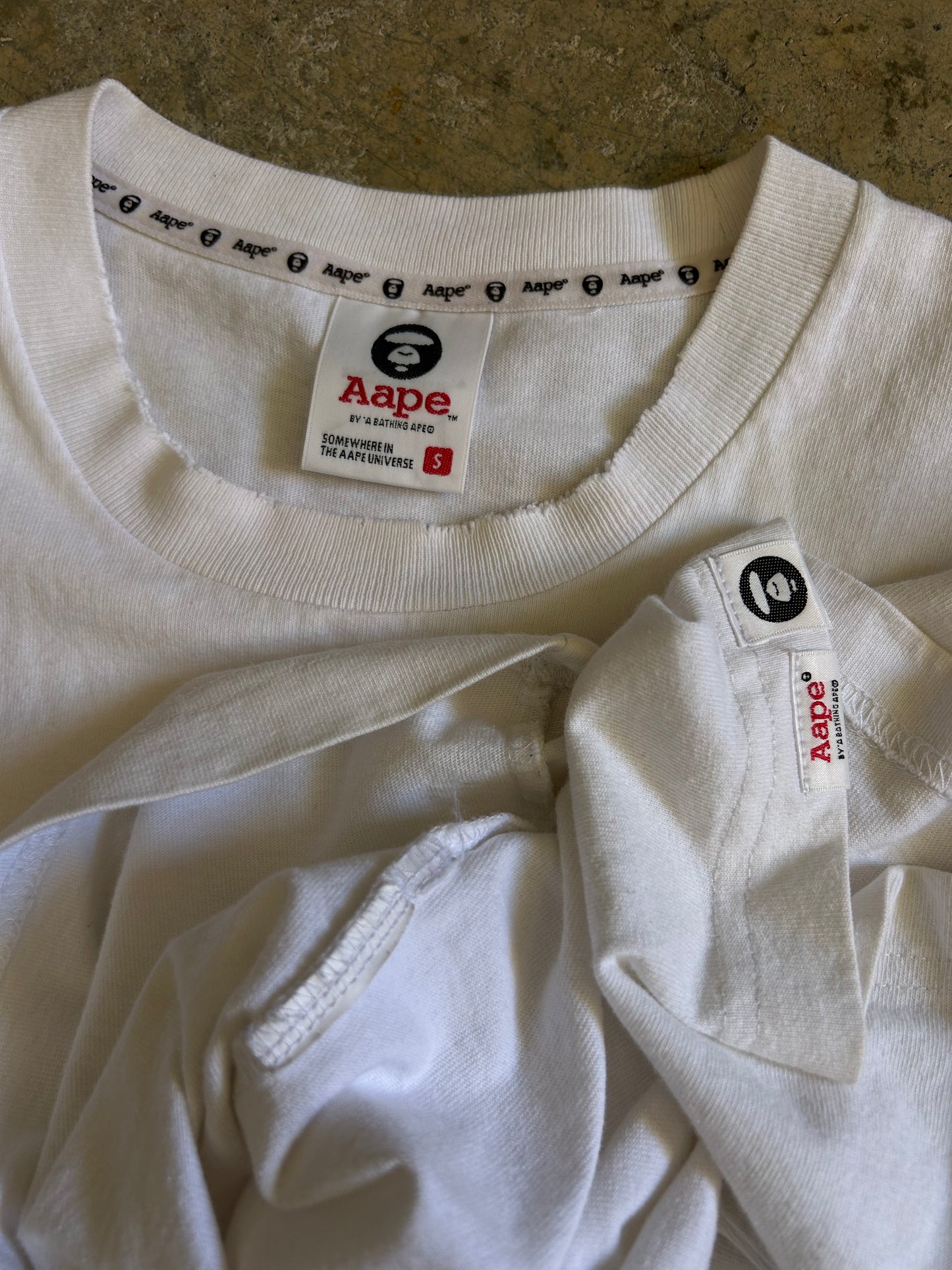 white t-shirt is the AAPE by A Bathing Ape logo-print T-shirt Small