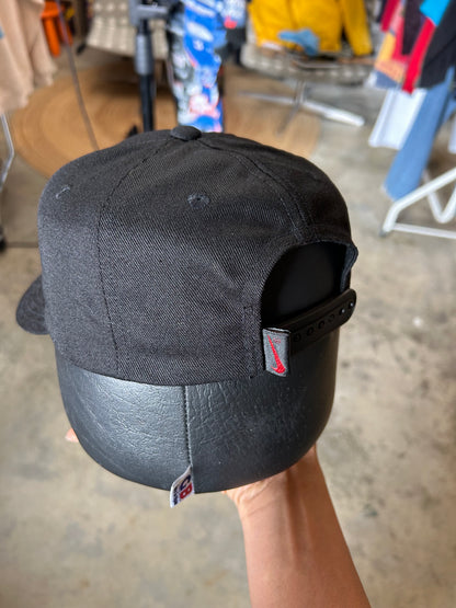 Vintage black Nike baseball cap featuring a white embroidered Swoosh Cotton