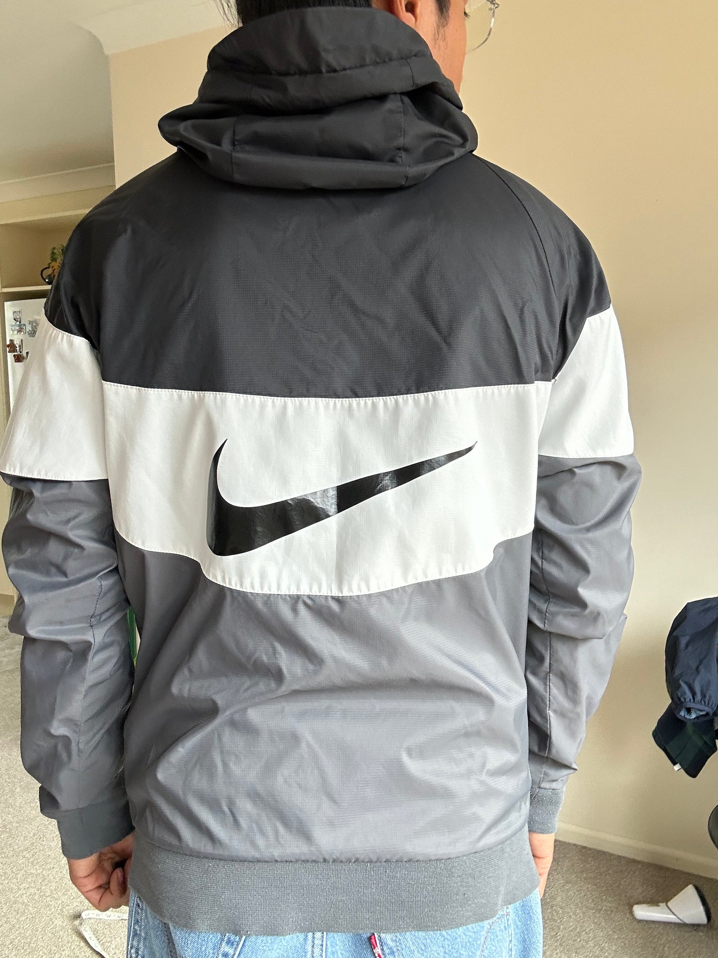 Nike Men's Sportswear Windrunner Jacket in a black, white, and dark grey colorway, model number AJ1396-010 Small