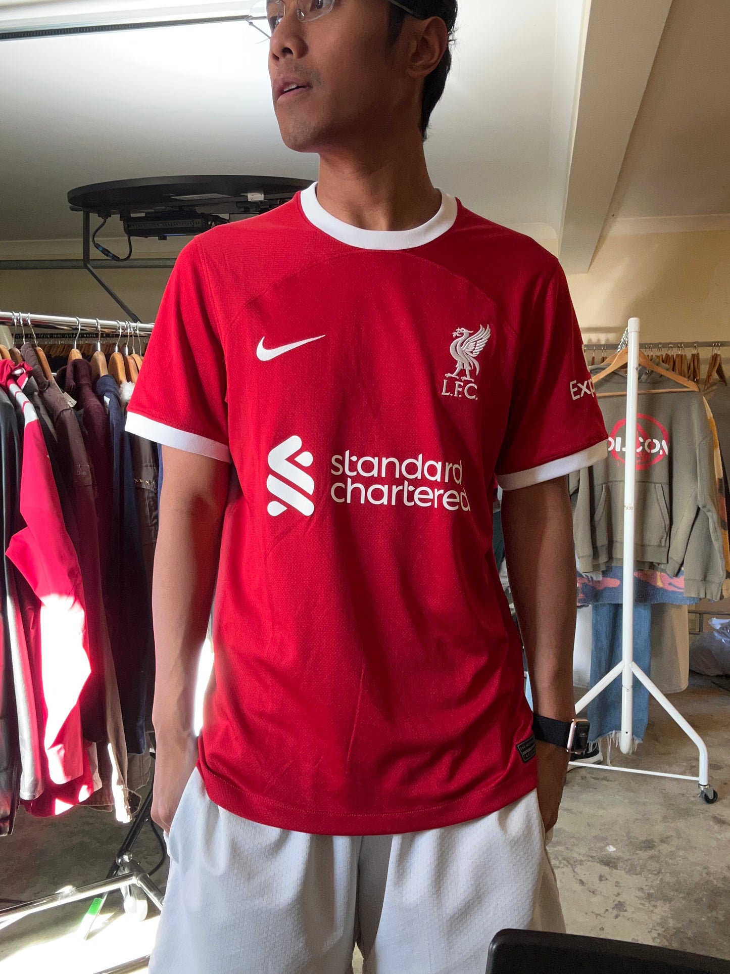 Nike Liverpool FC 2023/24 Home Jersey, featuring a classic red design with prominent white collar and sleeve cuffs. Medium